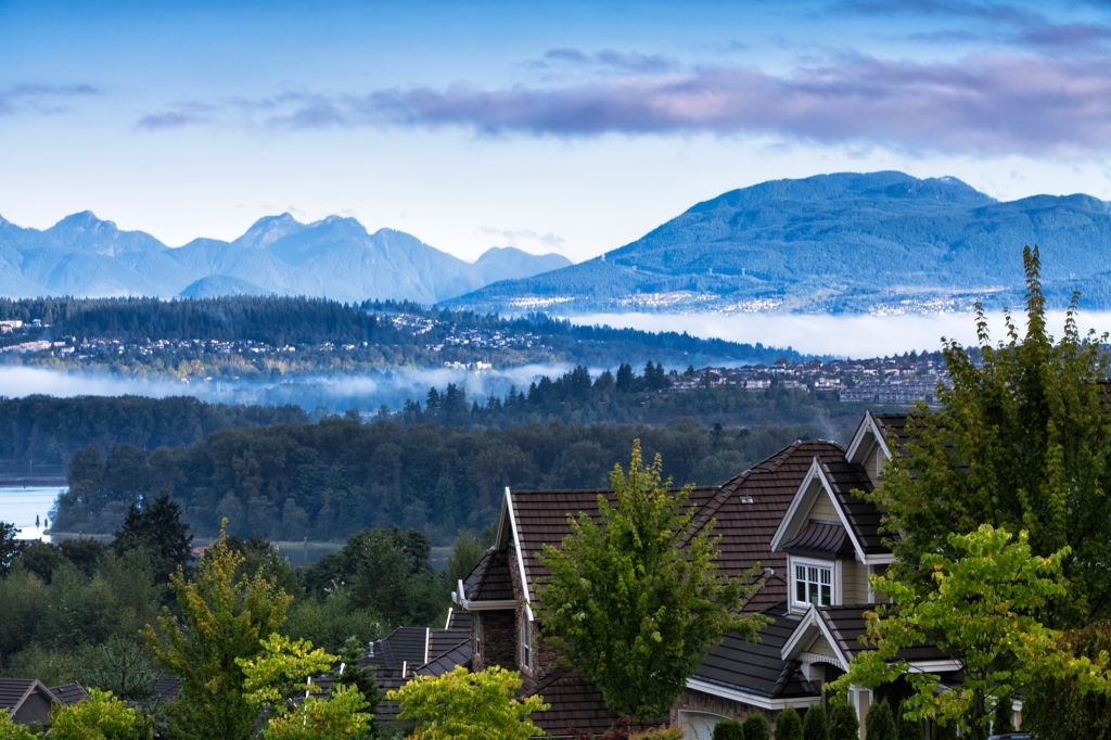 Residential area at Surrey near Fraser river in autumn in a early morning, Coquitlam cityscape in the background.